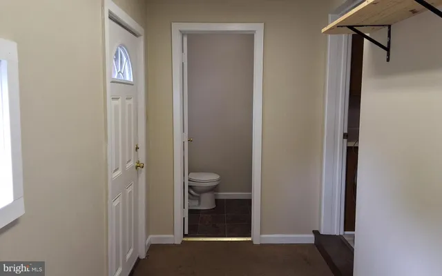 a view of a bathroom with a toilet and a shower