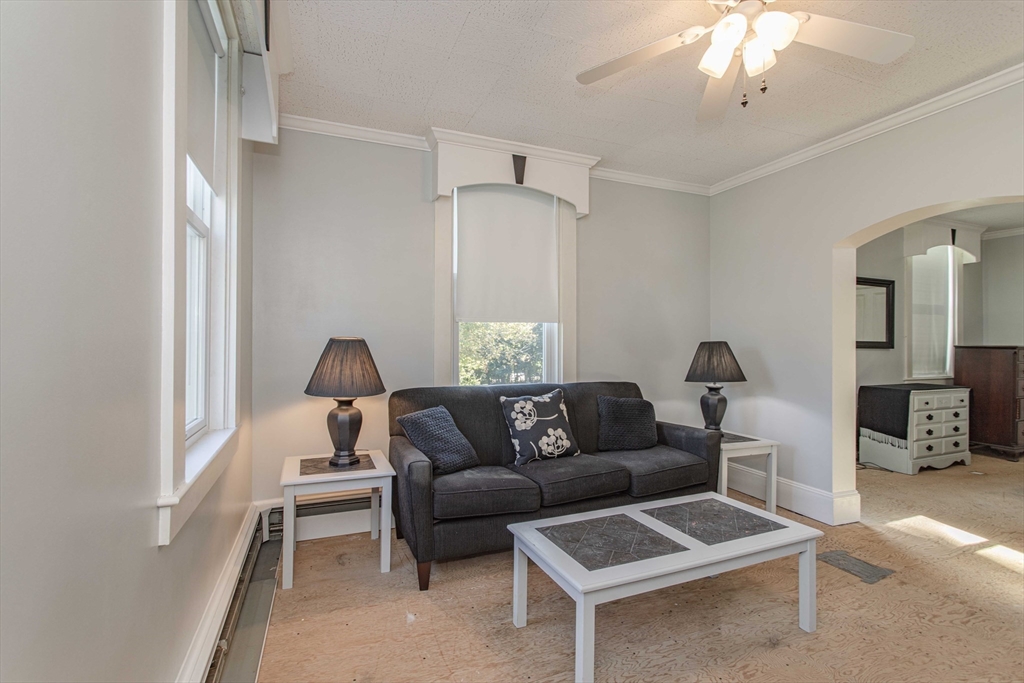 643 Center Street Raynham, MA 02767 - Photo 12 of 42 a living room with furniture and a chandelier