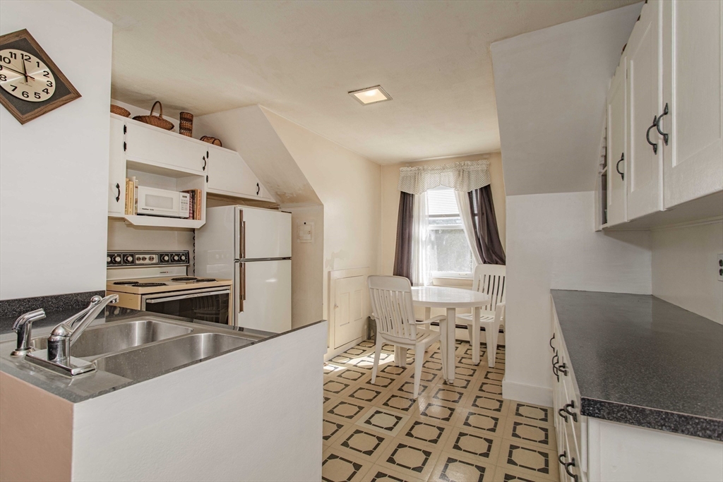 643 Center Street Raynham, MA 02767 - Photo 25 of 42 a kitchen that has a sink and a stove