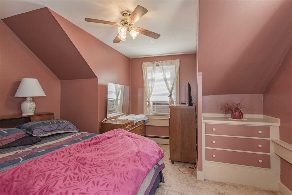 643 Center Street Raynham, MA 02767 - Photo 27 of 42 a bedroom with a bed and a chandelier