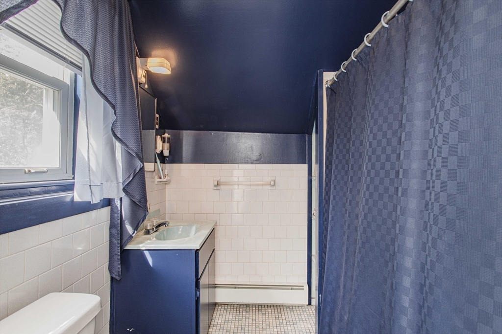 643 Center Street Raynham, MA 02767 - Photo 29 of 42 a bathroom with a sink and a mirror