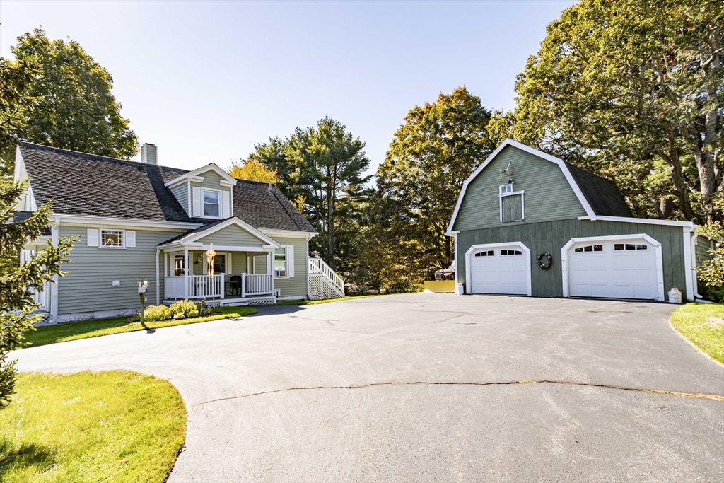 643 Center Street Raynham, MA 02767 - Photo 3 of 42 a front view of a house with a yard and garage