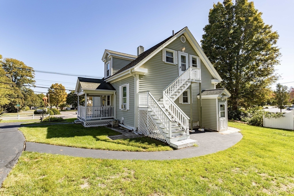 643 Center Street Raynham, MA 02767 - Photo 37 of 42 a front view of a house with a yard table and chairs