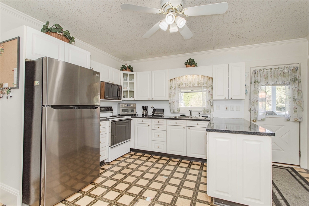 643 Center Street Raynham, MA 02767 - Photo 4 of 42 a kitchen with a refrigerator a sink and dishwasher