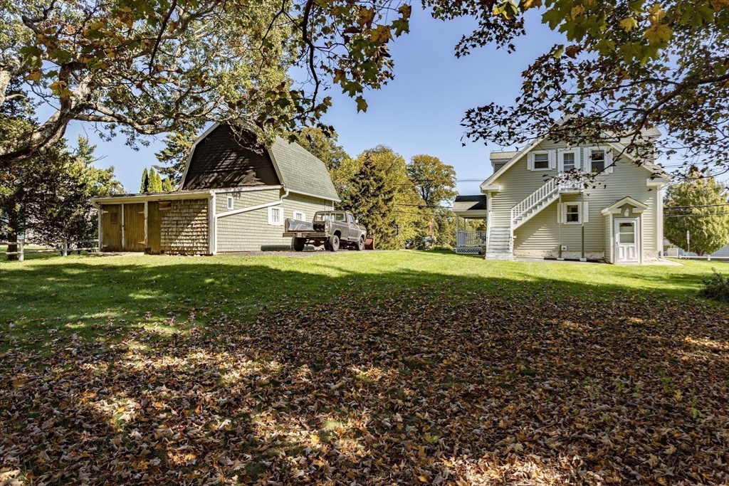 643 Center Street Raynham, MA 02767 - Photo 41 of 42 a front view of a house with a garden