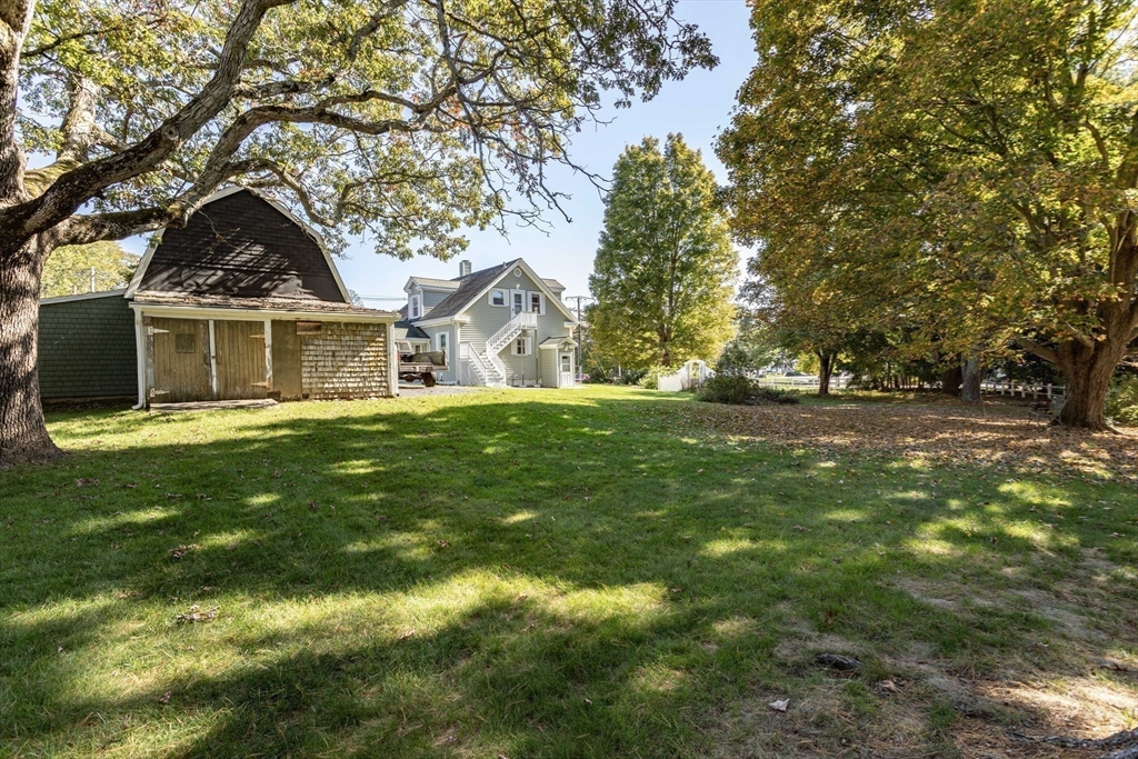 643 Center Street Raynham, MA 02767 - Photo 42 of 42 a front view of a house with a yard