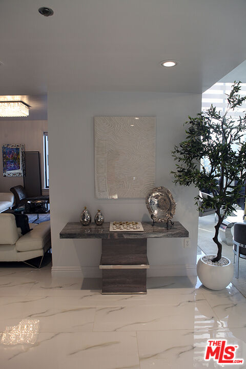 10550 Wilshire Boulevard, Unit 502 Los Angeles, CA 90024 - Photo 11 of 25 a living room with furniture flowerpot and a rug