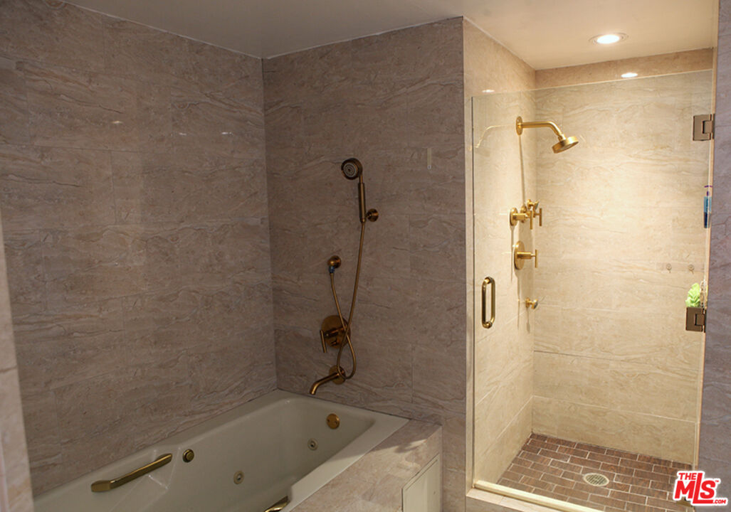 10550 Wilshire Boulevard, Unit 502 Los Angeles, CA 90024 - Photo 16 of 25 a bathroom with a bathtub and a shower