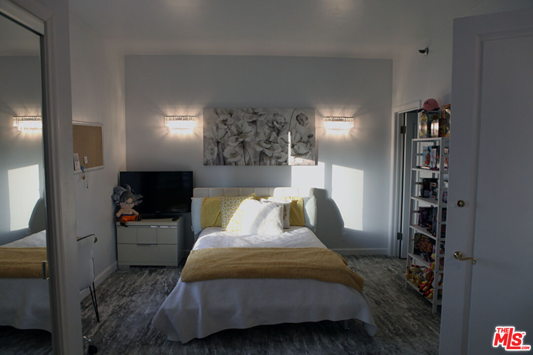 10550 Wilshire Boulevard, Unit 502 Los Angeles, CA 90024 - Photo 17 of 25 a bedroom with a bed and a television in it