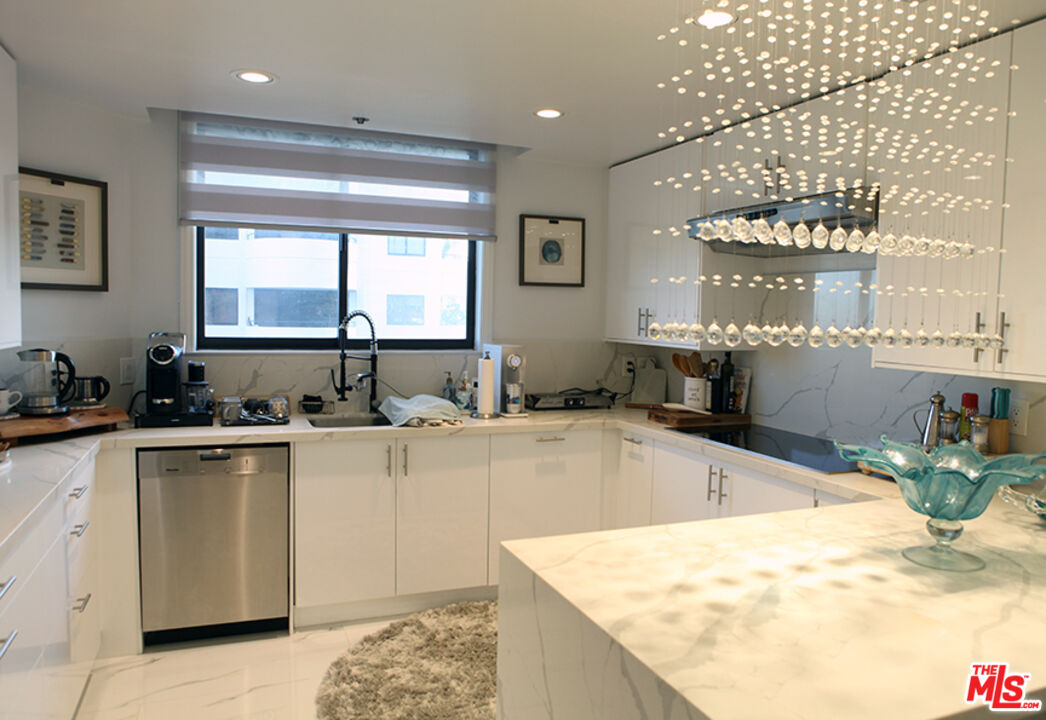 10550 Wilshire Boulevard, Unit 502 Los Angeles, CA 90024 - Photo 2 of 25 a large kitchen with kitchen island a sink stainless steel appliances and cabinets