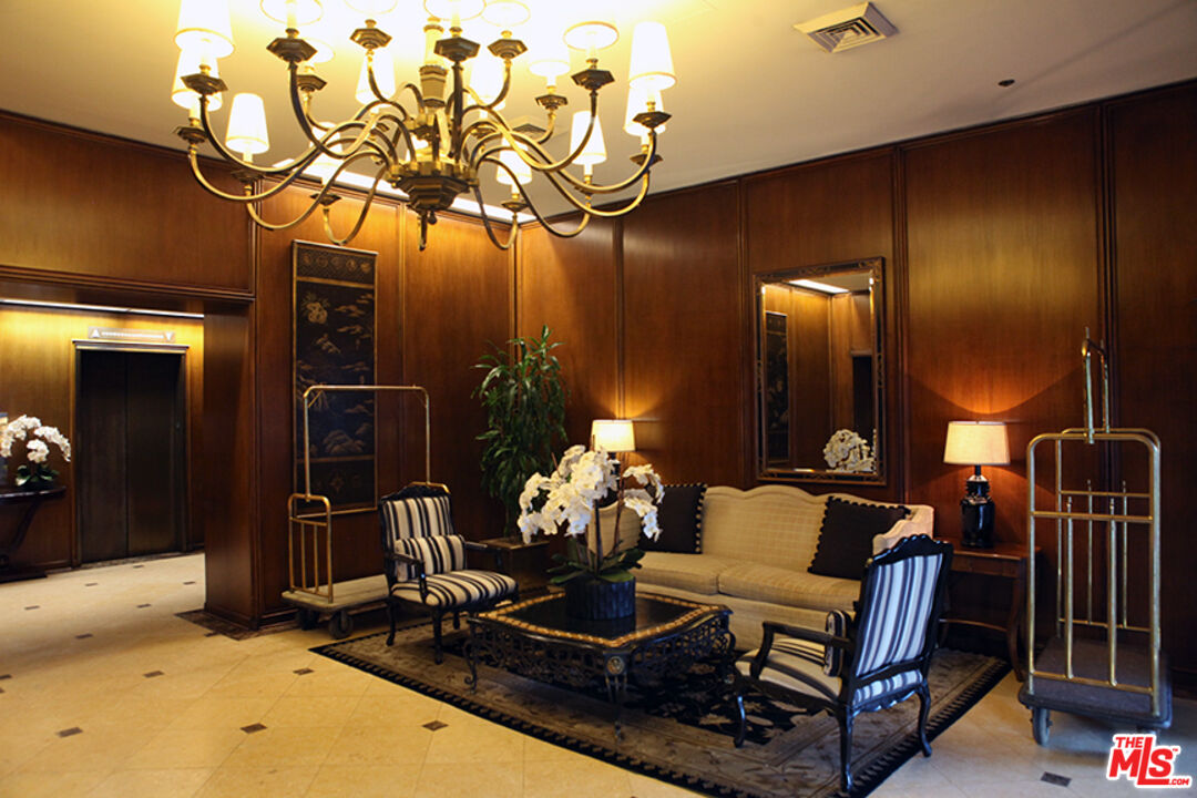 10550 Wilshire Boulevard, Unit 502 Los Angeles, CA 90024 - Photo 23 of 25 a living room with furniture gaming and a chandelier