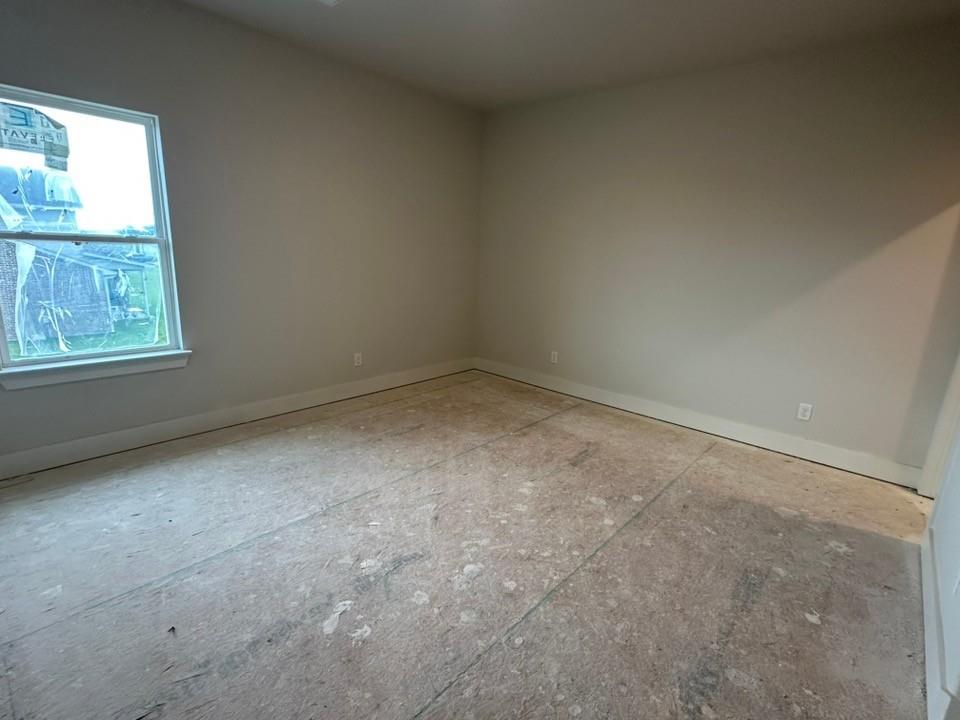 585 Brown Road Leonard, TX 75452 - Photo 23 of 29 Neutral-toned walls complement a large window with white trim, allowing for ample natural light