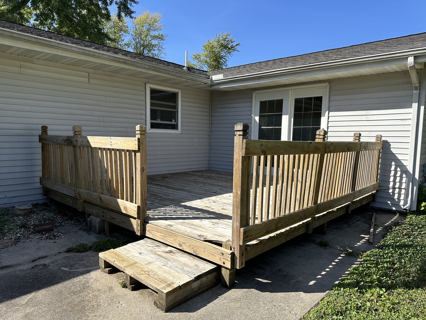 203 Ruby Street Villa Grove, IL 61956 - Photo 16 of 18 a view of a house with a small yard and wooden fence