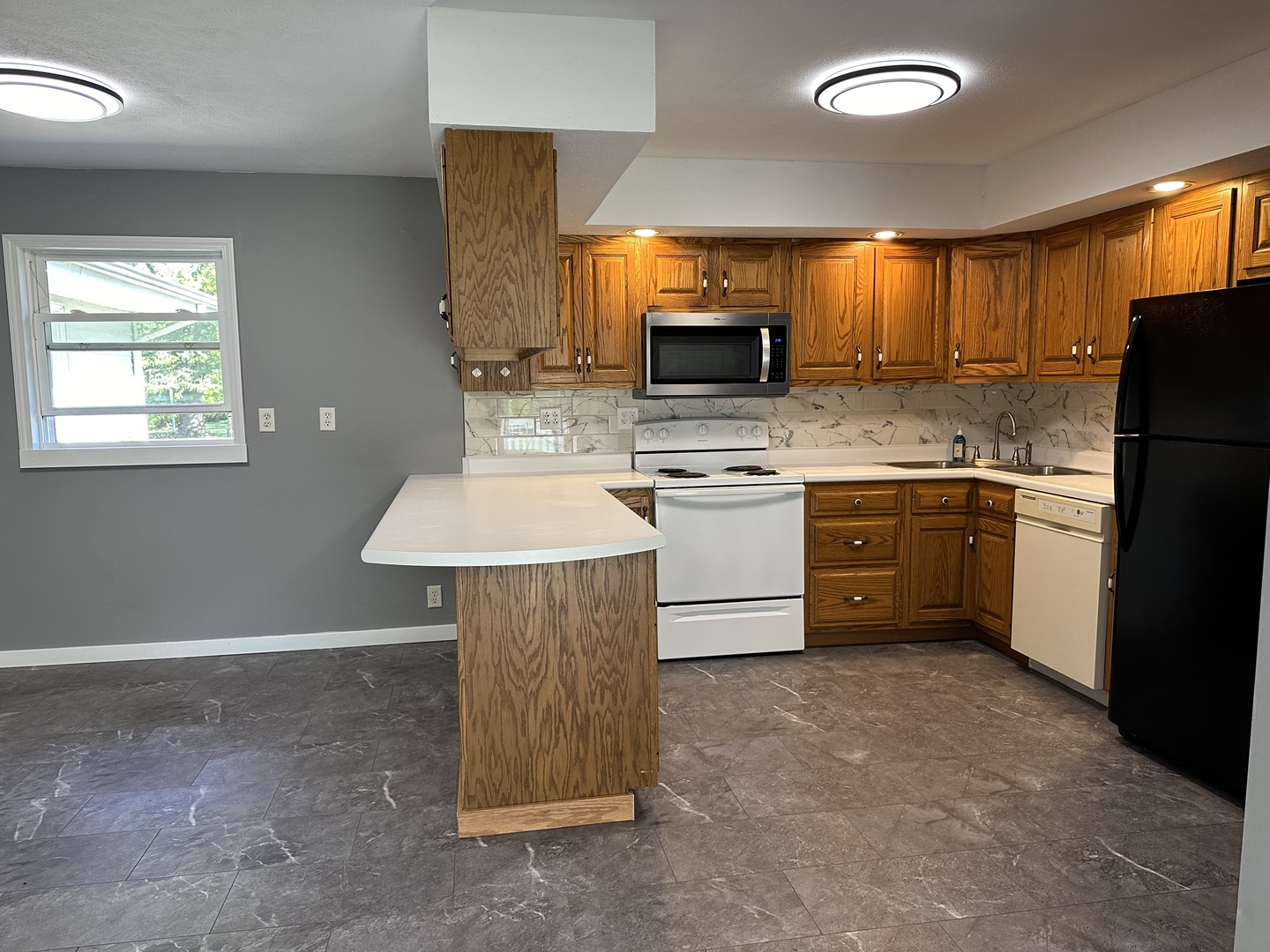 203 Ruby Street Villa Grove, IL 61956 - Photo 4 of 18 a kitchen with stainless steel appliances a sink stove and refrigerator