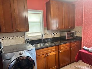 a kitchen with granite countertop a sink a stove and cabinets