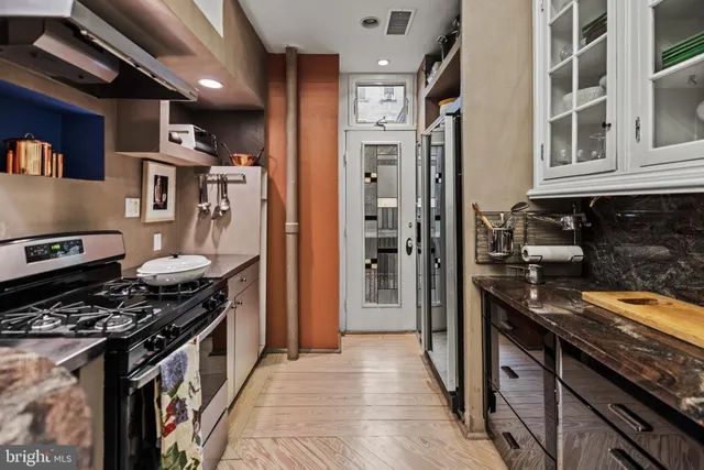a kitchen with stainless steel appliances granite countertop a stove and a refrigerator