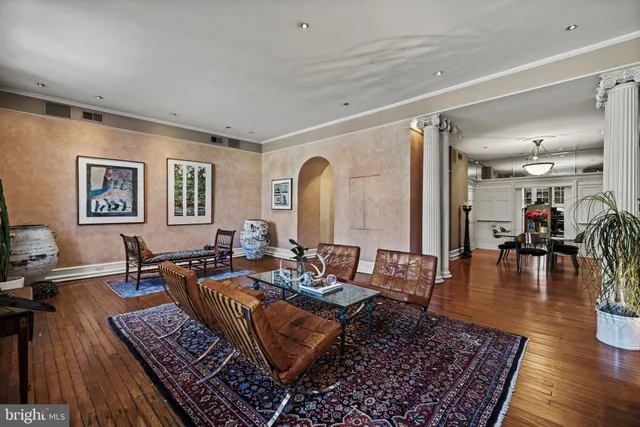 a living room with lots of furniture and wooden floor
