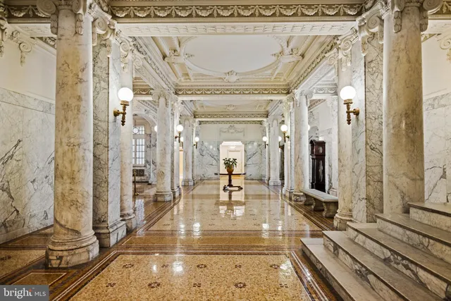 a view of a hallway with wooden floor and furniture