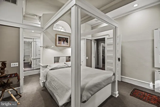 a bedroom with a large bed and a view of bedroom