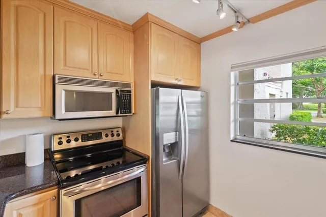 a kitchen with stainless steel appliances a refrigerator and a stove top oven