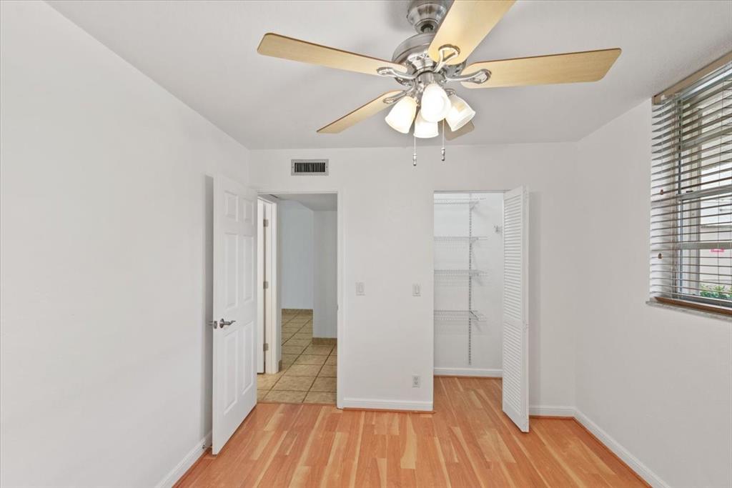 9470 Poinciana Place, Unit 103 Davie, FL 33324 - Photo 17 of 27 wooden floor in an empty room with a window