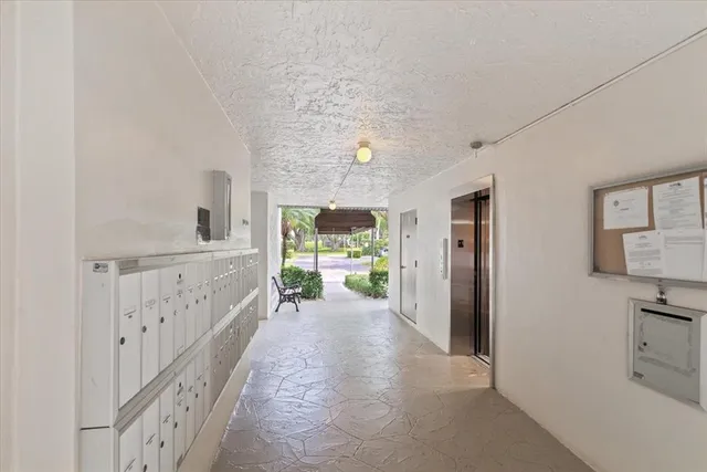 a hallway with furniture and a large window