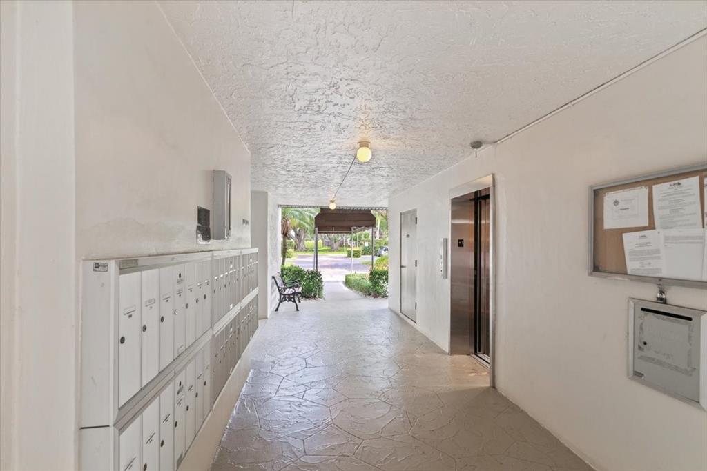 9470 Poinciana Place, Unit 103 Davie, FL 33324 - Photo 27 of 27 a hallway with furniture and a large window