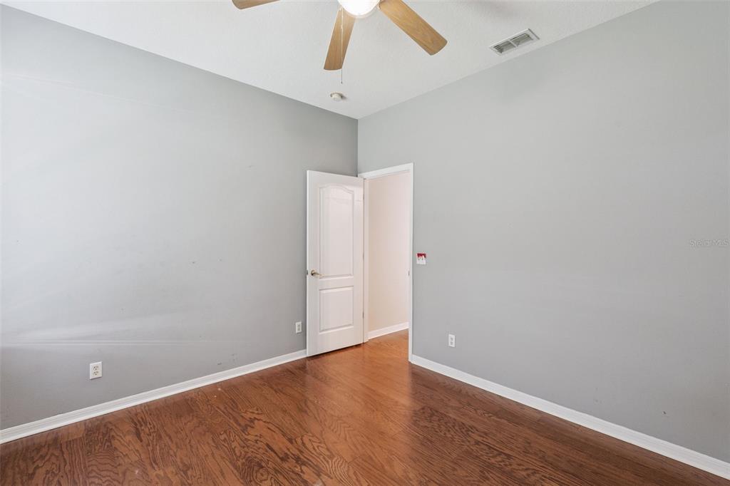 774 Lancer Circle Ocoee, FL 34761 - Photo 20 of 35 an empty room with wooden floor and fan