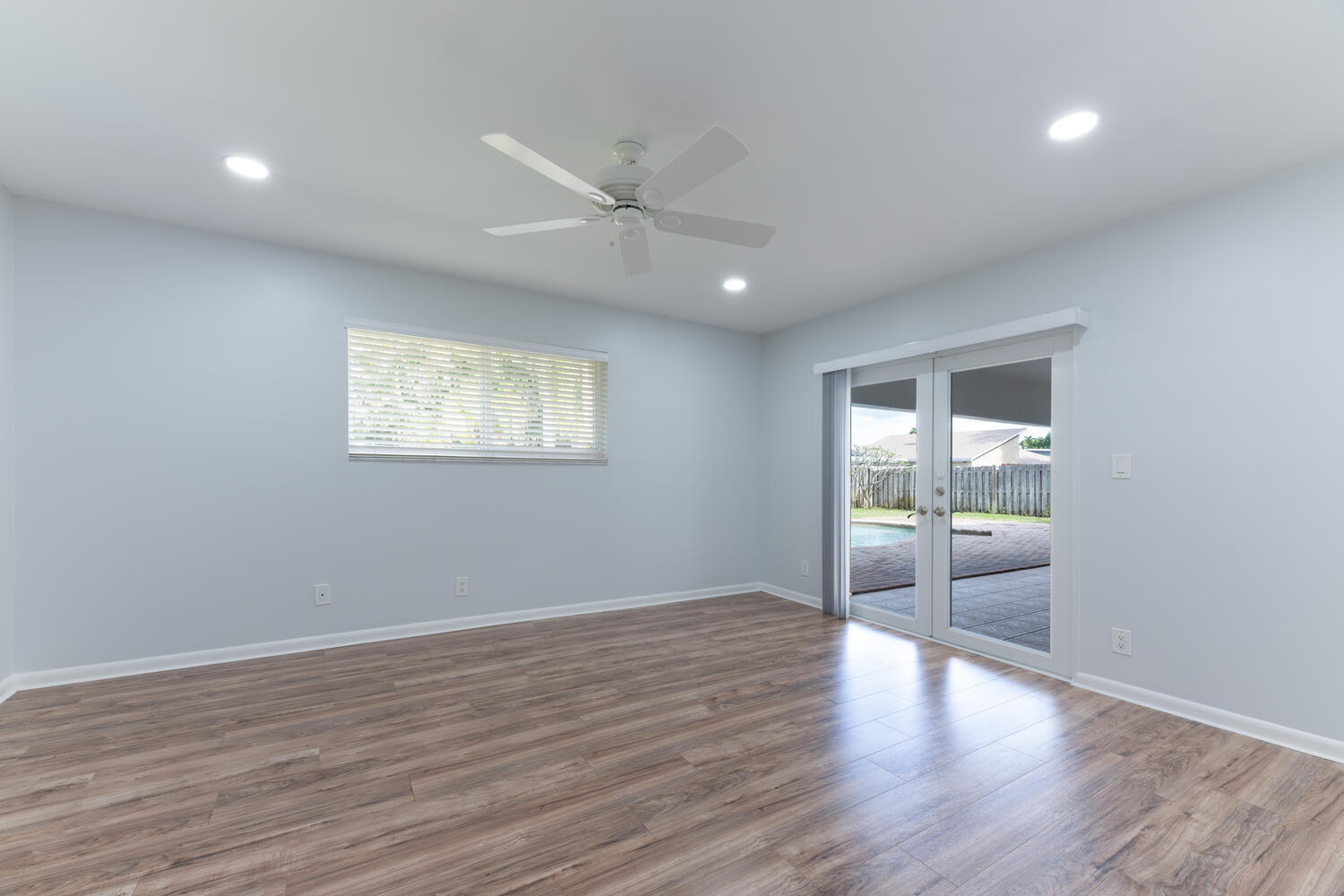 4695 Brandywine Drive Boca Raton, FL 33487 - Photo 19 of 28 a view of an empty room with a window and wooden floor