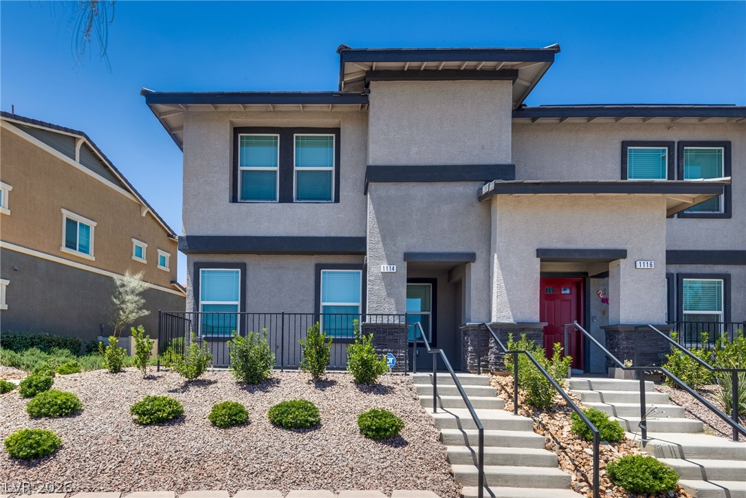 1114 Scarlet Sparrow Street Henderson, NV 89011 - Photo 2 of 25 Modern townhomes with clean lines, xeriscaping, and inviting front entrances.