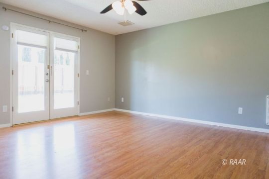 327 Henry Street Ridgecrest, CA 93555 - Photo 15 of 30 a view of an empty room with wooden floor and a window