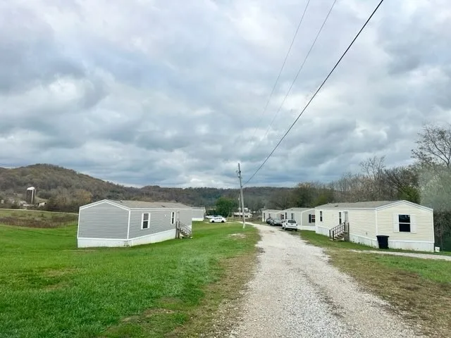 a view of an house with backyard and garden