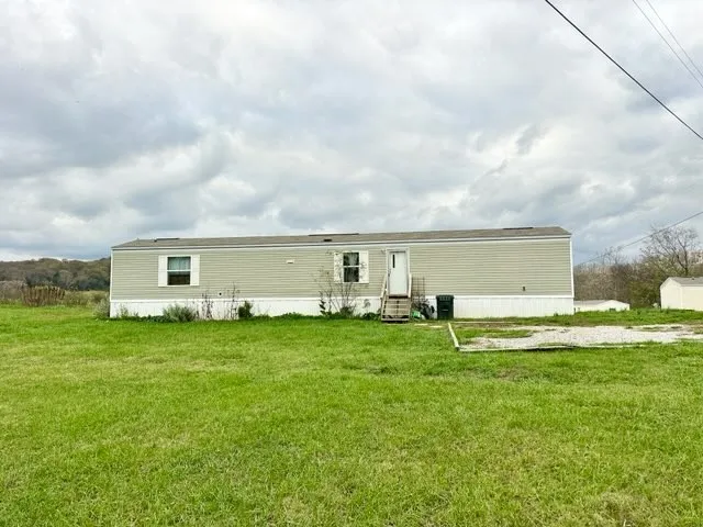 a backyard of a house with table and chairs