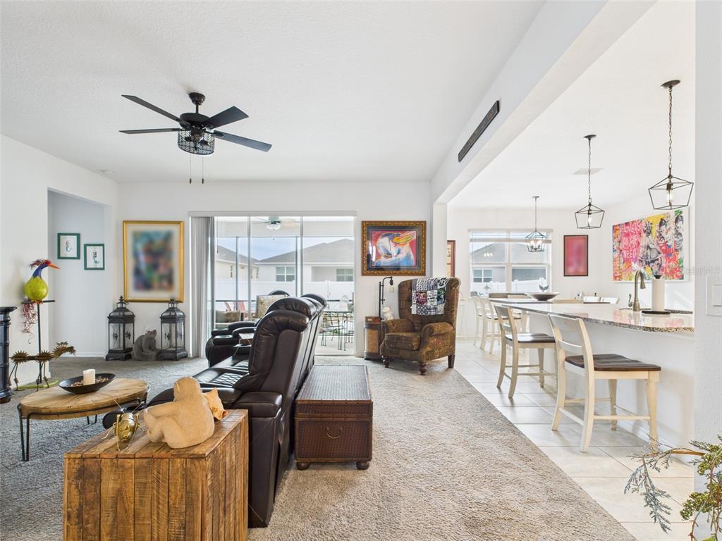 6506 Southwest 75th Ave Road Ocala, FL 34474 - Photo 13 of 28 a living room with furniture a window and gym equipment
