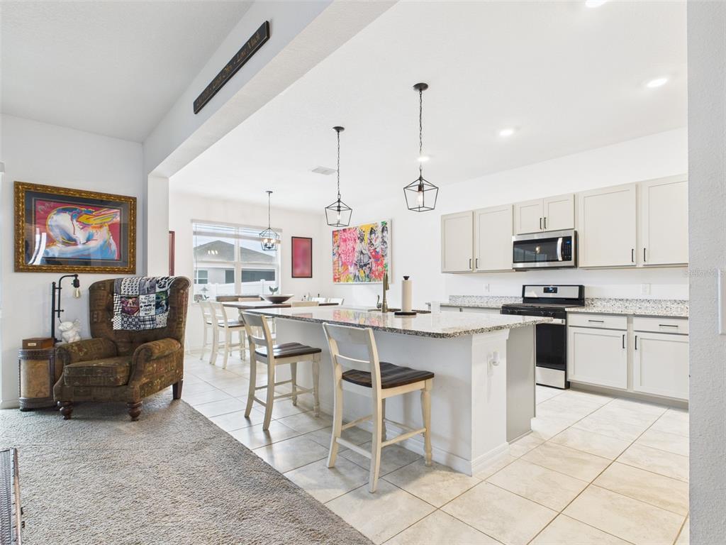 6506 Southwest 75th Ave Road Ocala, FL 34474 - Photo 14 of 28 a kitchen with stainless steel appliances kitchen island granite countertop a sink and cabinets