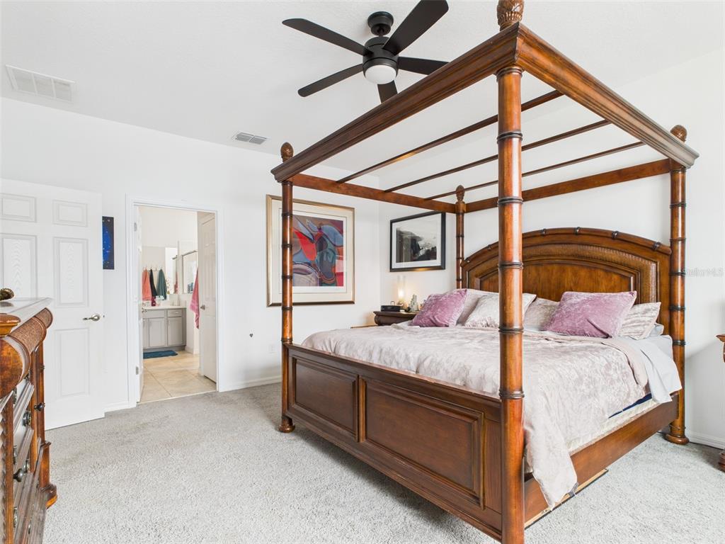 6506 Southwest 75th Ave Road Ocala, FL 34474 - Photo 20 of 28 a bedroom with a bed and a chandelier