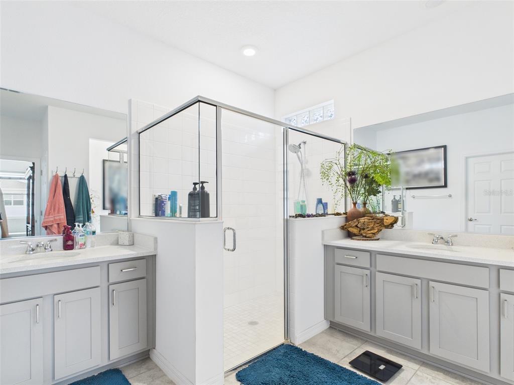 6506 Southwest 75th Ave Road Ocala, FL 34474 - Photo 22 of 28 a bathroom with a double vanity sink and mirror