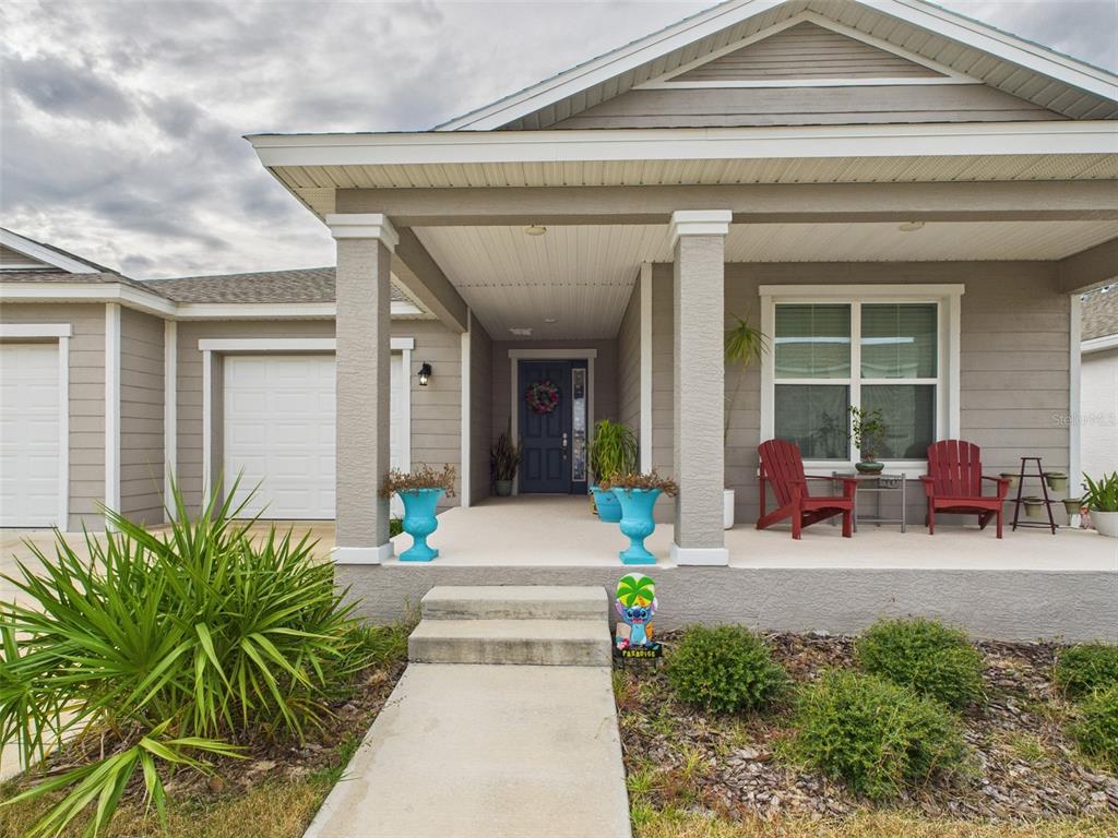 6506 Southwest 75th Ave Road Ocala, FL 34474 - Photo 3 of 28 a front view of a house with outdoor seating and a potted plant