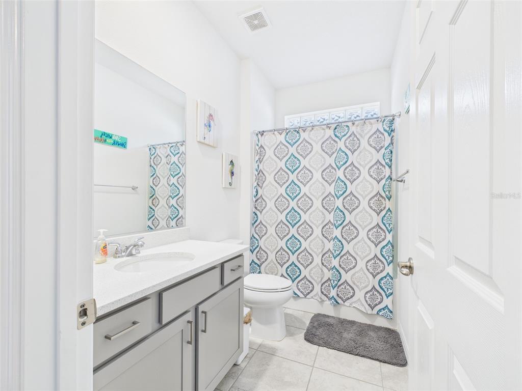 6506 Southwest 75th Ave Road Ocala, FL 34474 - Photo 5 of 28 a bathroom with a sink a toilet and shower curtain