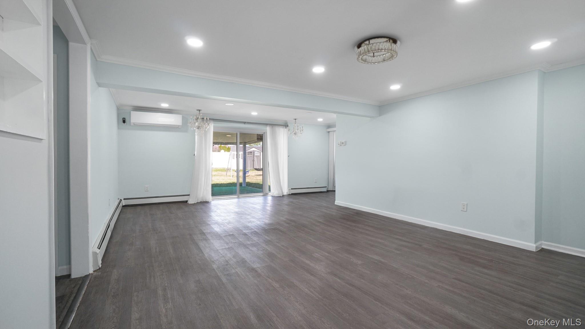 63 Blacksmith Road Levittown, NY 11756 - Photo 10 of 25 Spacious room featuring wood-finish flooring, recessed lighting, and a contemporary ceiling fixture