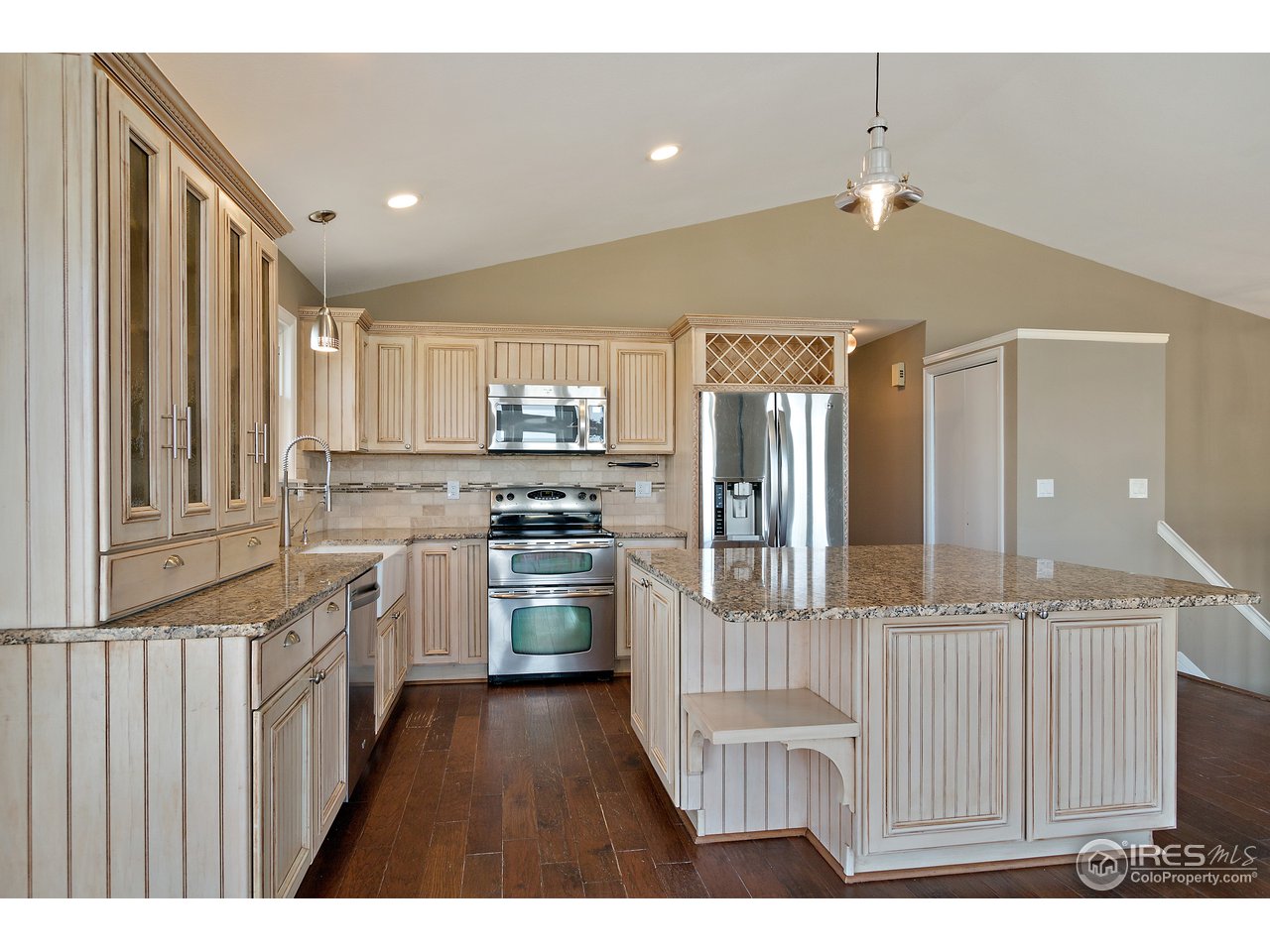 9088 North Awl Road Parker, CO 80138 - Photo 12 of 40 a kitchen with cabinets and wooden floor