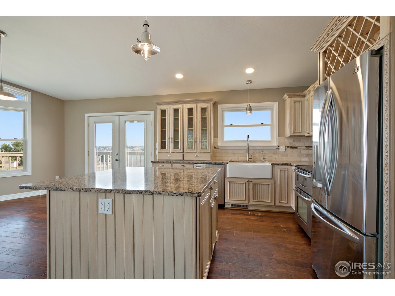 9088 North Awl Road Parker, CO 80138 - Photo 13 of 40 a kitchen with refrigerator cabinets and a sink