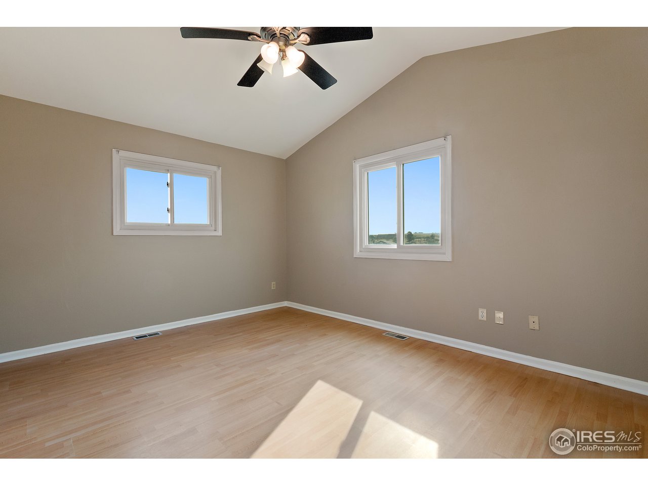 9088 North Awl Road Parker, CO 80138 - Photo 14 of 40 an empty room with wooden floor and windows
