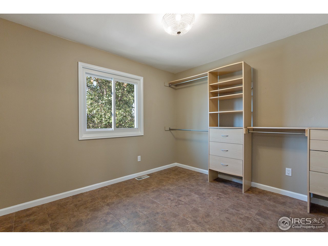9088 North Awl Road Parker, CO 80138 - Photo 23 of 40 an empty room with closet and windows