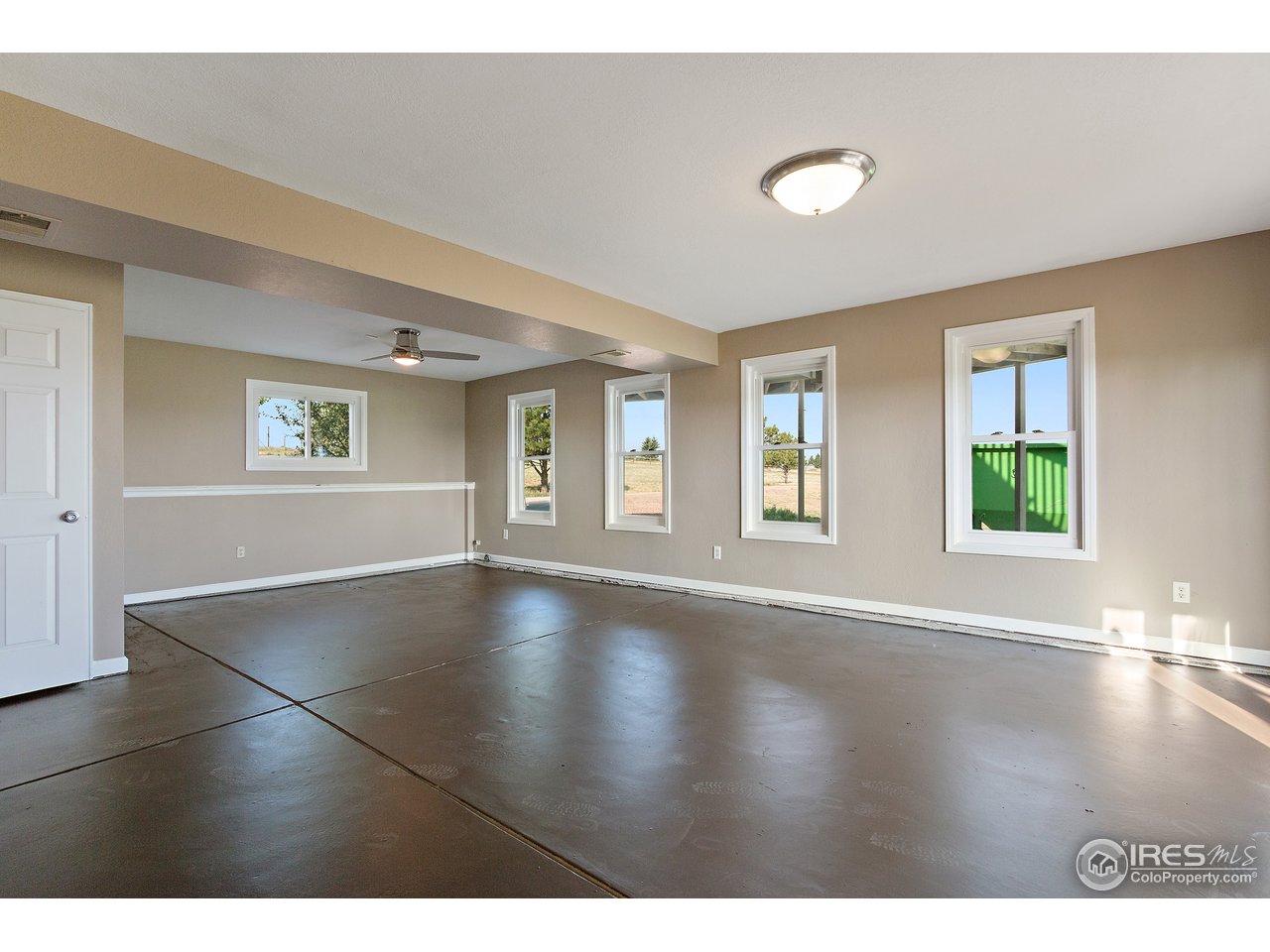 9088 North Awl Road Parker, CO 80138 - Photo 24 of 40 a view of an empty room with window and wooden floor