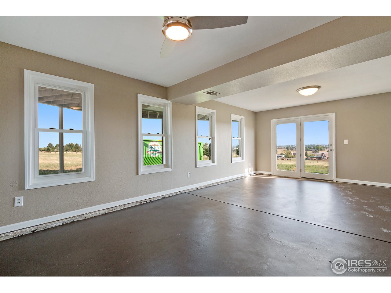 9088 North Awl Road Parker, CO 80138 - Photo 26 of 40 a view of an empty room with window and wooden floor