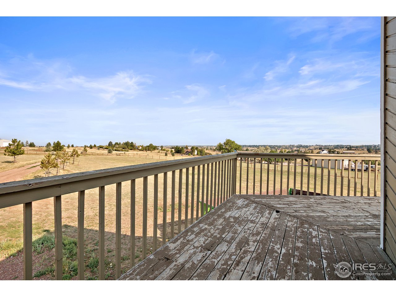 9088 North Awl Road Parker, CO 80138 - Photo 30 of 40 a view of a balcony with wooden floor