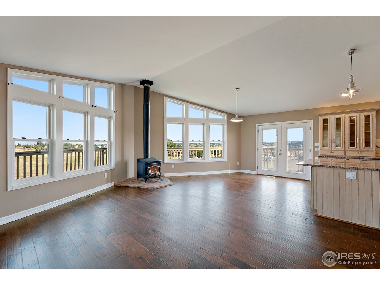 9088 North Awl Road Parker, CO 80138 - Photo 6 of 40 a view of an empty room with wooden floor and a window