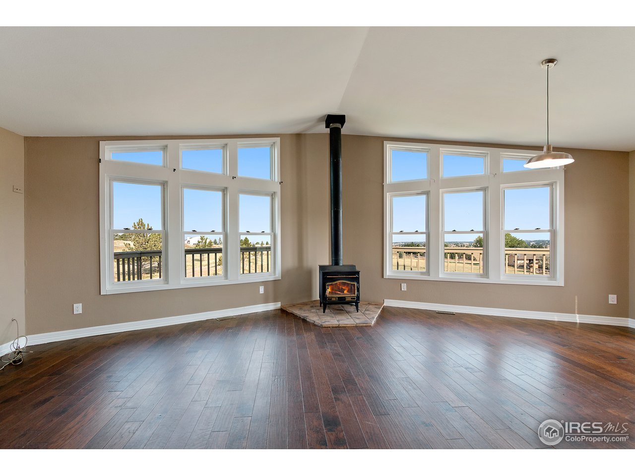 9088 North Awl Road Parker, CO 80138 - Photo 7 of 40 a view of an empty room with a window and wooden floor