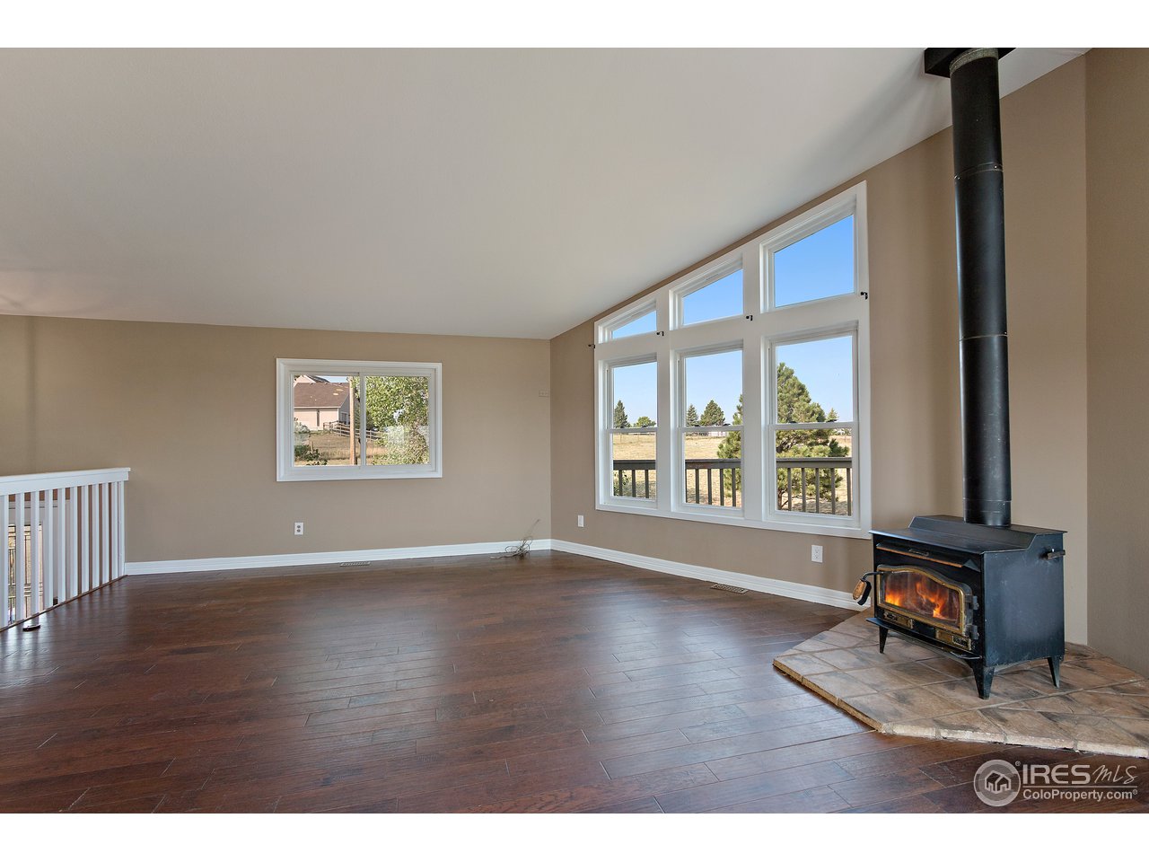 9088 North Awl Road Parker, CO 80138 - Photo 8 of 40 a view of an empty room with a window and wooden floor